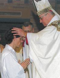 photo of Bishop Bullock laying his hands on David Wanish