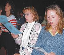 photo of Holly Irving, Kathy Fortlage and Jennifer Farmer singing opening song at Mass