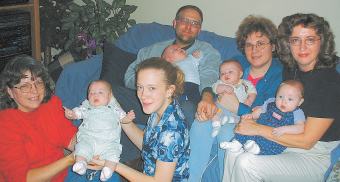photo of Lime Ridge quadruplets, their parents and volunteers
