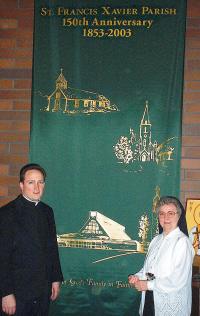 photo of Fr. Tom Kelley, Sr. John Rose Acker and St. Francis Xavier Parish, Cross Plains anniversary banner