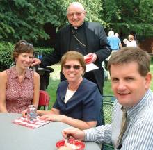 photo of Bishop Emeritus William H. Bullock with three Diocese of Madison staff members