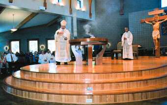 photo of Bishop Morlino incensing altar at Our Lady of the Assumption Church in Beloit