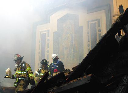 photo of firefighters reverently retrieving ciborium containing the Blessed Sacrament inside smoldering ruins of St. Raphael Cathedral, Madison