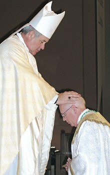 photo of Bishop Robert J. Carlson laying his hands on Bishop Paul J. Swain during the Rite of Ordination on Thursday, Oct. 26, at St. Joseph Cathedral in Sioux Falls, S.D.