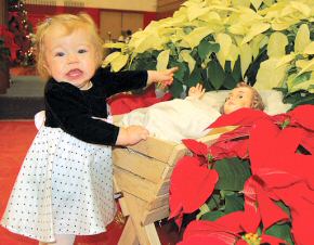 photo of Berlyn Hicks, of Darlington, excitedly pointing to the baby Jesus at the annual Apostolate to the Handicapped Christmas Party