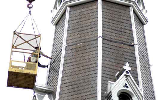 Construction worker removing steeple